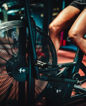 Fit woman working out on the exercise bike at the gym