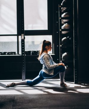 Portrait of attractive young woman doing yoga or pilates exercise